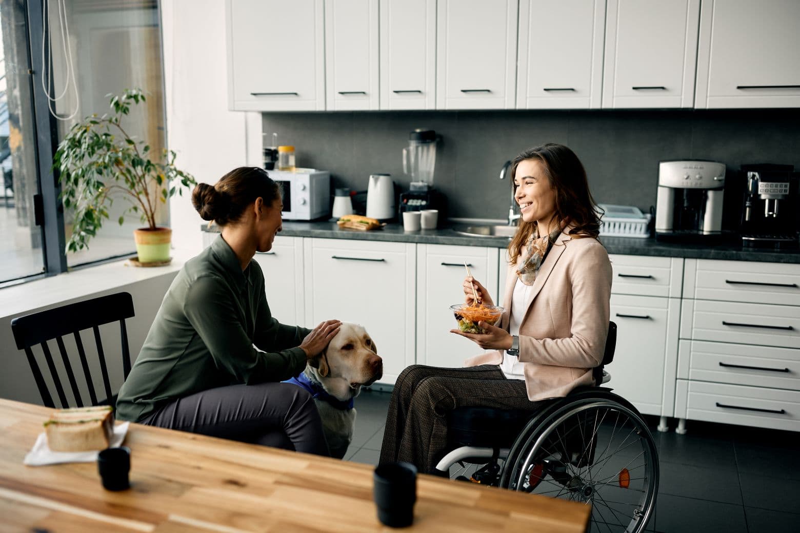 Friends with their dog in the kitchen